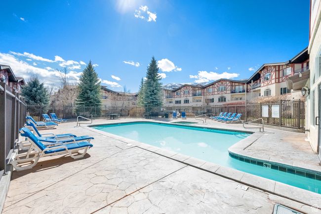Community pool featuring fence and a patio area | Image 35