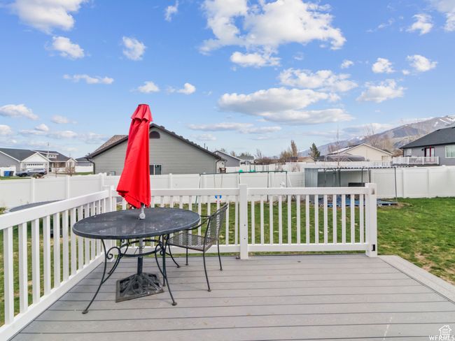 Wooden deck featuring outdoor dining space and a residential view | Image 22