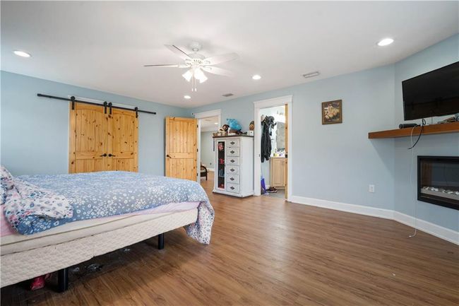 Bedroom featuring recessed lighting, baseboards, and wood finished floors | Image 17