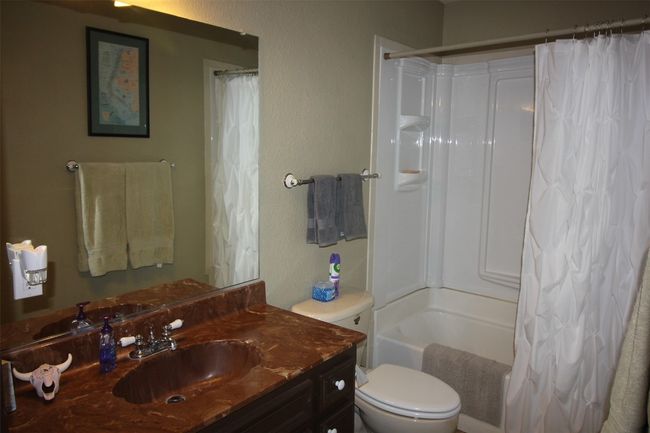 Full bathroom with vanity, shower / bath combo, built-in storage | Image 19