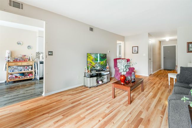 Living area with wood finished floors and baseboards | Image 5