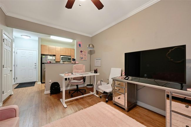 Office with ceiling fan, ornamental molding, and light hardwood / wood-style floors | Image 4
