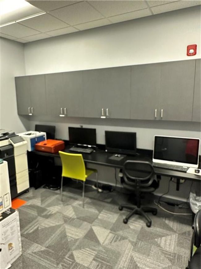 Office area featuring carpet, a paneled ceiling, and built in desk | Image 10