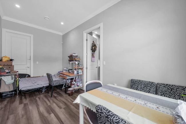 Bedroom with wood finished floors, ornamental molding, and recessed lighting | Image 15
