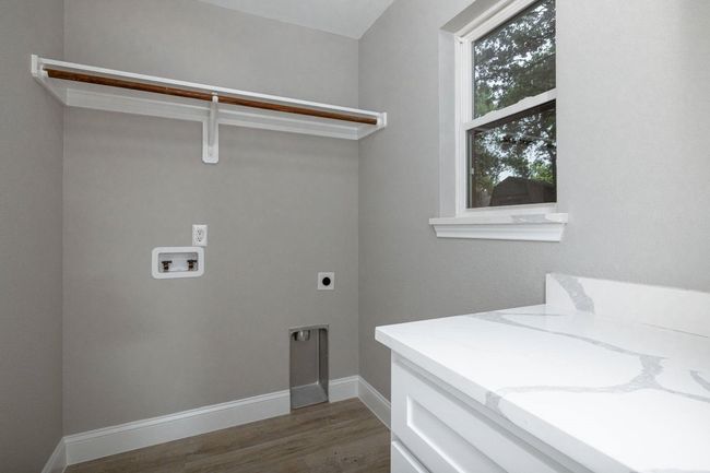 Washroom with electric dryer hookup, washer hookup, and wood finished floors | Image 23