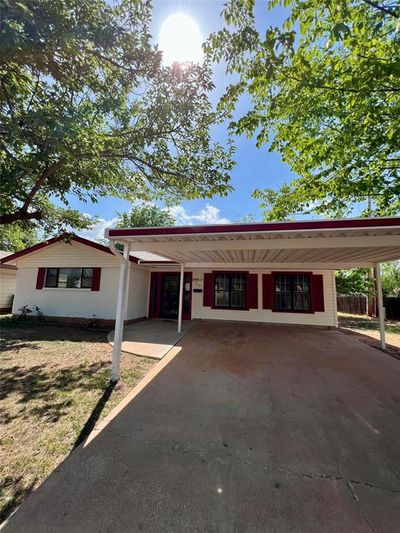 Ranch-style house featuring a carport | Image 1