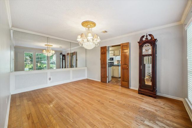This dining room connects to the kitchen through double wooden doors. | Image 6