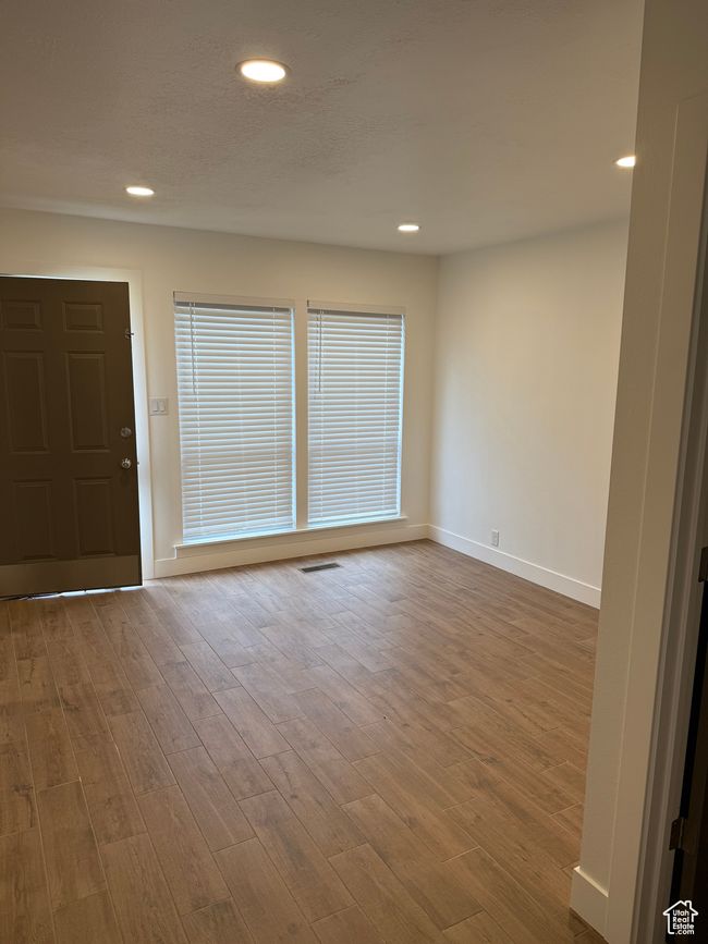 Unfurnished room featuring recessed lighting, visible vents, baseboards, and wood finished floors | Image 8