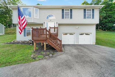 Split foyer home featuring a garage and a front lawn | Image 1