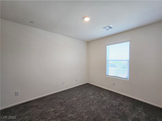 Spare room featuring dark colored carpet and baseboards | Image 20
