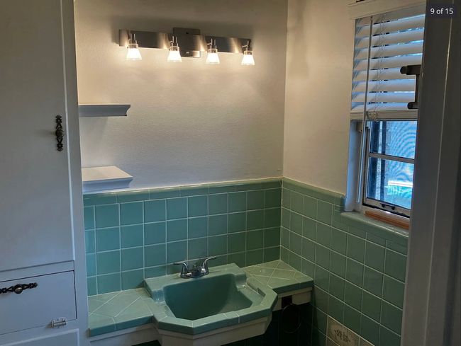 Bathroom with tile walls and a wainscoted wall | Image 8