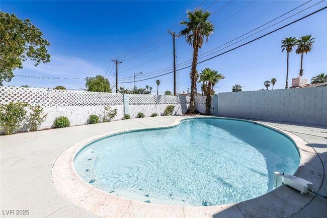 View of swimming pool with a fenced backyard | Image 51