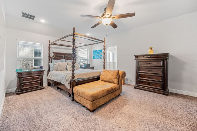 Primary bedroom suite featuring a ceiling fan, recessed lighting, and ensuite bathroom | Image 21
