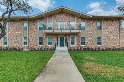 View of front of property featuring a front yard and a balcony | Image 1