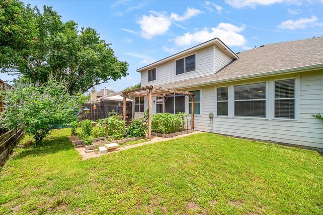 Rear view of house with a garden, a pergola, and roof with shingles | Image 37