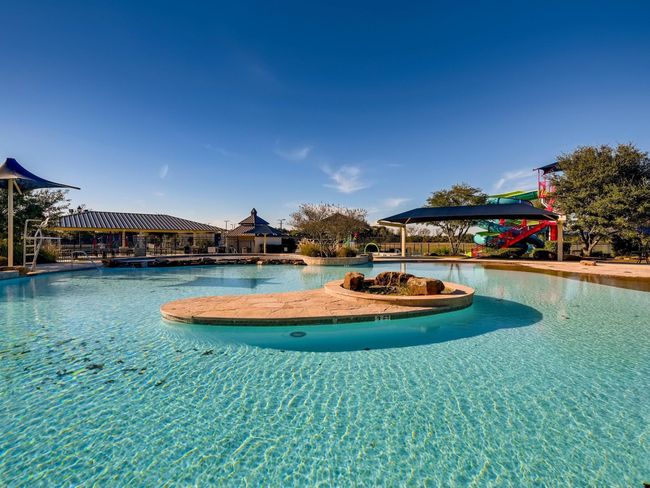 This community pool is located at the front of the neighborhood and has convenient access to outdoor restroom facilities. There is another competition pool down the street that is home to the Firethorne Firefish swim team! | Image 32