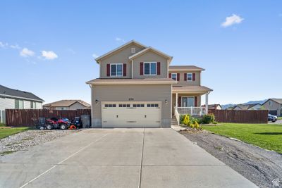 View of front property with a garage and a front lawn | Image 1