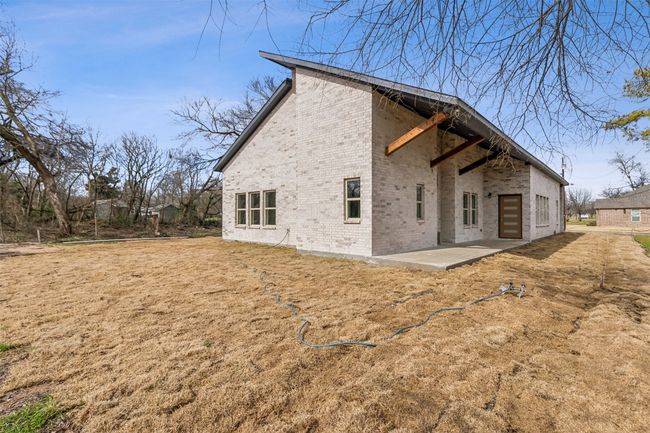 Rear view of property featuring brick siding and a patio | Image 35