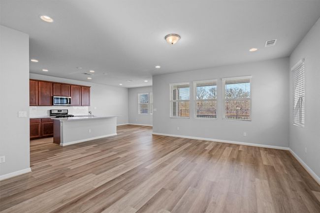 Unfurnished living room featuring light wood finished floors and recessed lighting | Image 5