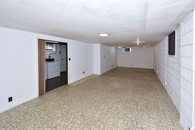 Below grade area featuring baseboards, washer / clothes dryer, and tile patterned floors | Image 44