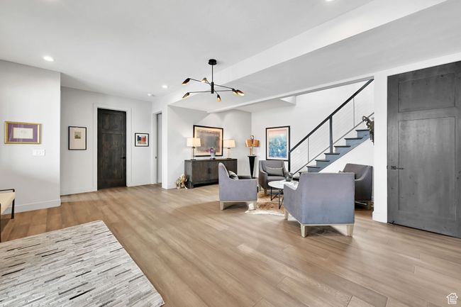 Foyer with hardwood floors and contemporary stairway leading to main living area. | Image 11