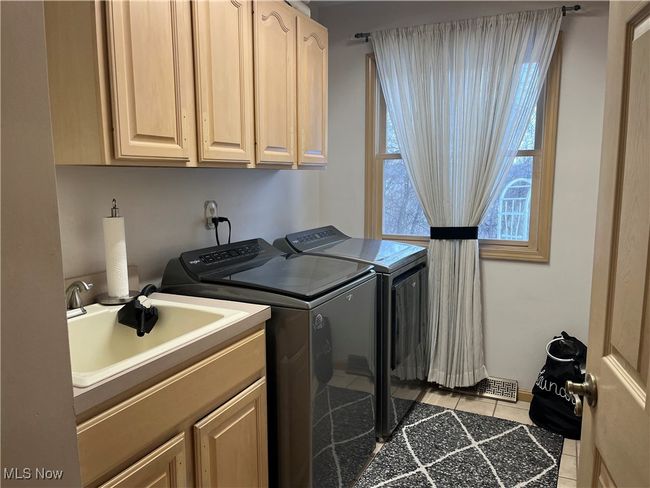 Laundry room with cabinets, ceramic floors and sink. (Washer and Dryer negotiable) | Image 35