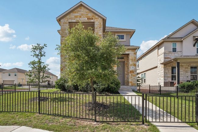 View of front of property featuring stone siding and a gate | Image 24