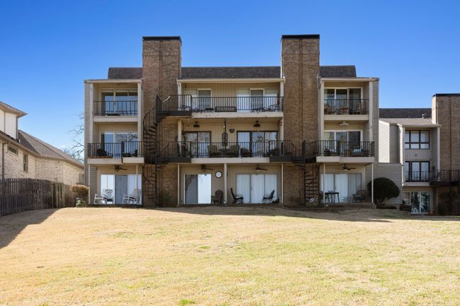 Back of Condo building, looks out over lake, green space and dock. | Image 26