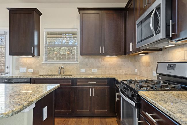 A charming window over the sink allows natural light inside. | Image 6