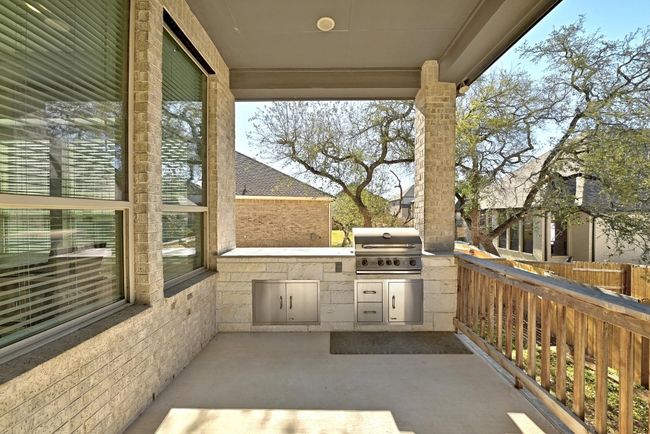 Enjoy outdoor dining and relaxation on the covered patio, complete with a built-in gas grill for year-round gatherings. | Image 25