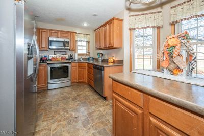 Kitchen featuring a wealth of natural light, appliances with stainless steel finishes, and sink | Image 3