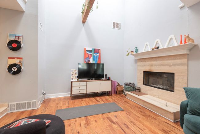 Family area with beautiful fireplace, lots of light coming from the skylight into this room | Image 30