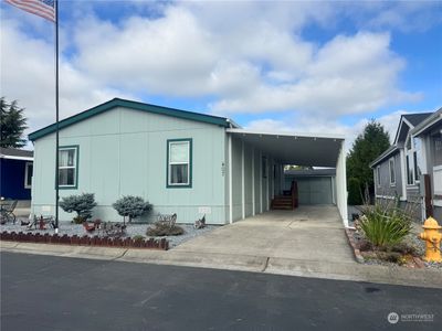 One of finest homes in The River Estates Manufactured Home Park is now available! Newly built in 2017, this home sits on the quietest street in the park. Enjoy the great view of Mount Rainier. This 55+ park is known for its community clubhouse with a game room featuring 2 pool tables, 3 libraries, a grand hall with fireplace and kitchen. There's a swimming pool, Spa. There are crafting and games groups. And the best park managers to help you feel right at home. There's a full slate of neighborhood activities, including Thursday donuts and coffee. Soon the community will be hosting an Oktoberfest dinner and a Thanksgiving feast. | Image 1