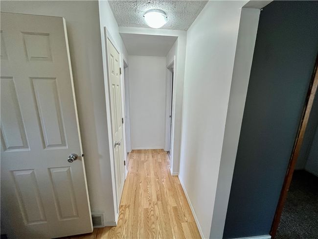 Hallway leading to Bathroom and Bedrooms | Image 7