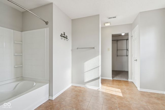 full bathroom with tile patterned floors, shower / bath combination, and baseboards | Image 40