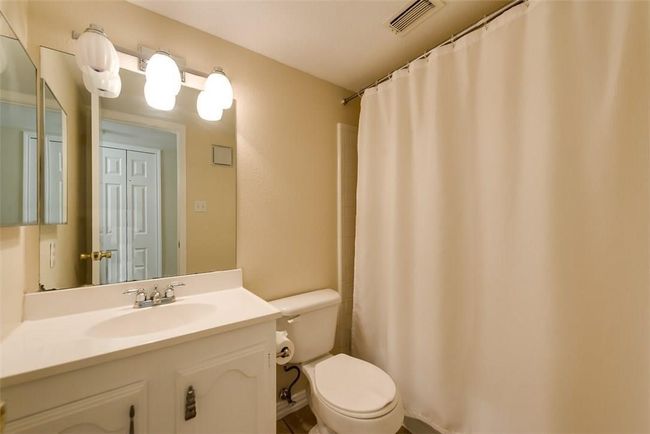 Full bath featuring toilet, vanity, and a shower with curtain | Image 13