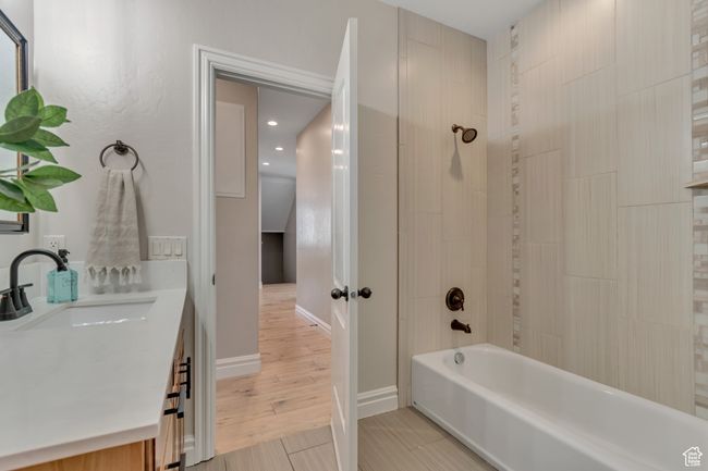 Bathroom featuring tub / shower combination, vanity, and recessed lighting | Image 14