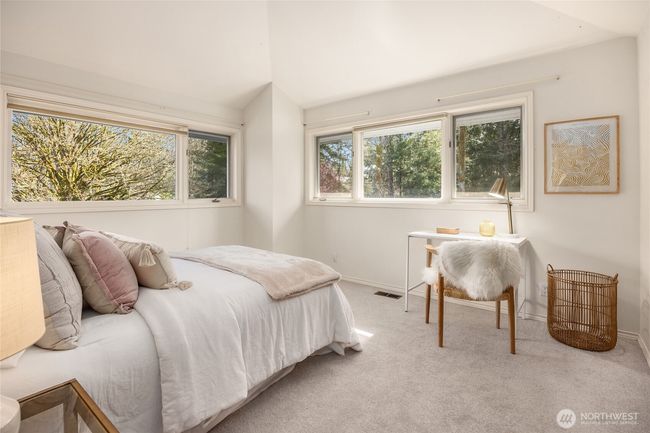 Third bedroom is equally spacious with vaulted ceilings. This bedroom and second bedroom also feature extra storage behind the closet to the right. | Image 34