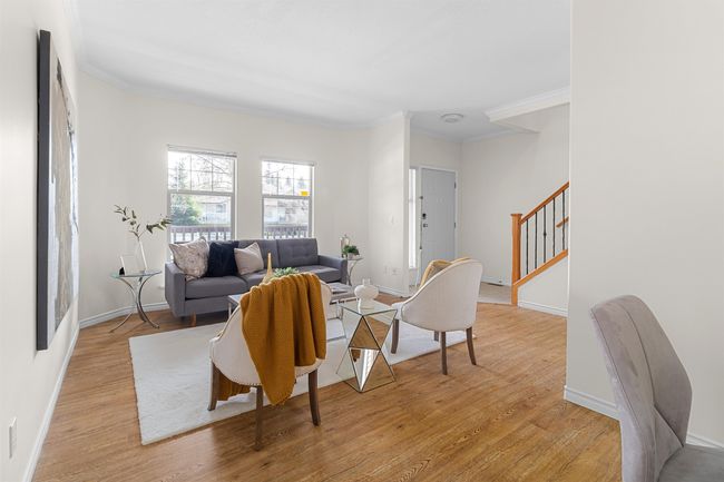 Living area featuring stairs, ornamental molding, light wood-style floors, and baseboards | Image 5