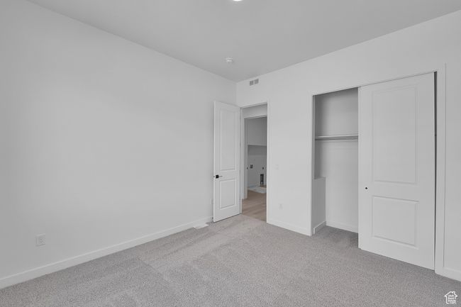 Unfurnished bedroom with carpet floors, baseboards, and a closet | Image 20