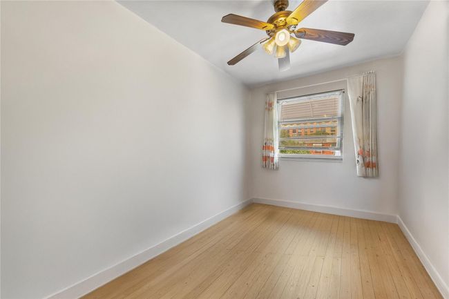 Unfurnished room featuring light wood-type flooring and ceiling fan | Image 7