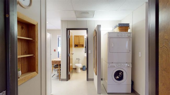 Laundry area featuring stacked washer / drying machine | Image 27