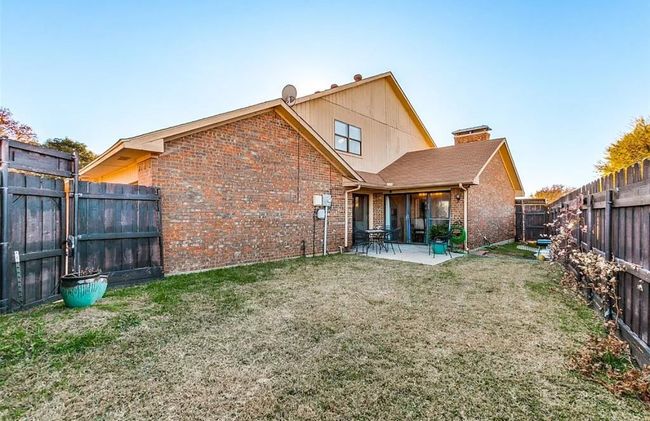 Rear view of house with brick siding and a patio | Image 15