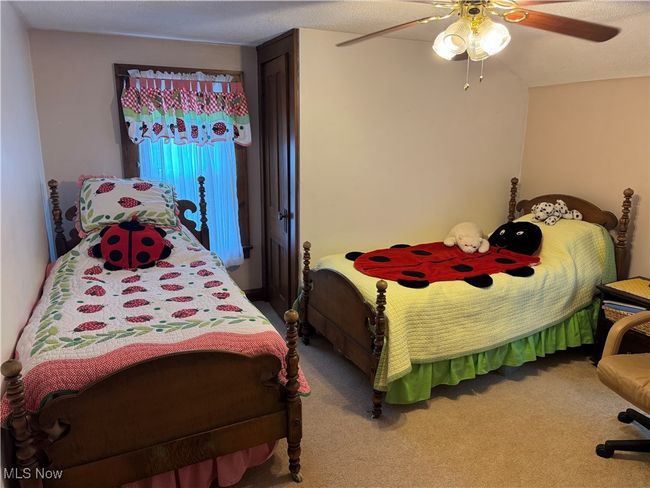 Carpeted bedroom with ceiling fan | Image 13