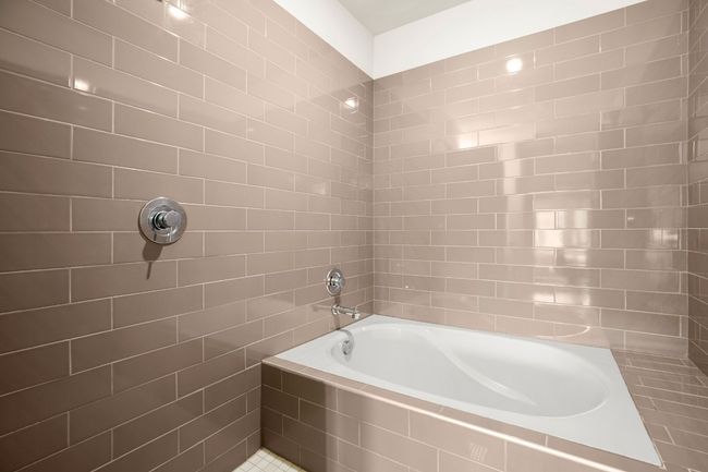 Bathroom with tiled shower, tiled bath, and tile walls | Image 18
