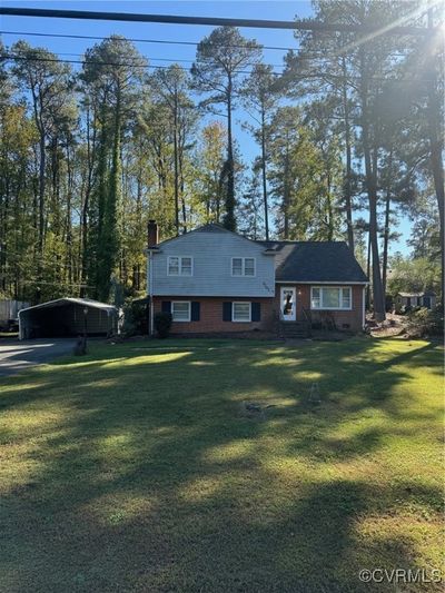 Split level home featuring a front lawn | Image 1