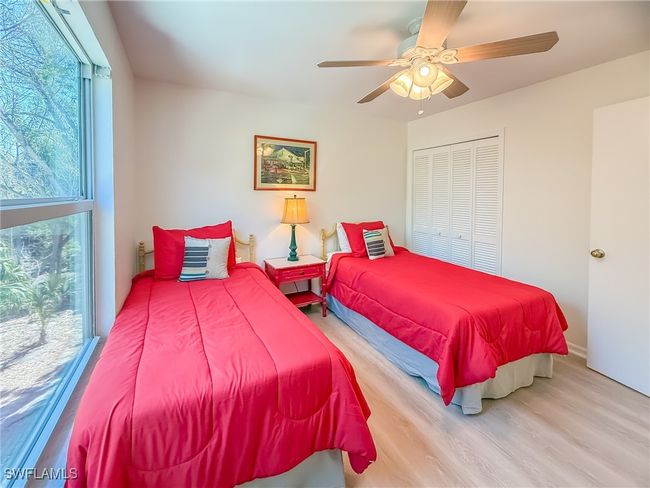Bedroom featuring a closet, a ceiling fan, and wood finished floors | Image 43