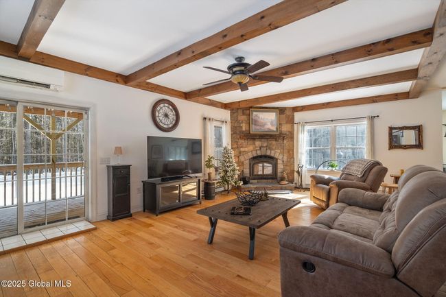 Livingroom with sliding doors to side yard fenced in covered deck | Image 4