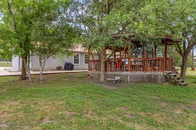 Rear view of house with a yard and a deck | Image 13