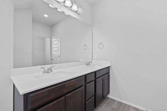 Bathroom with double vanity and baseboards | Image 23